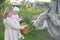 Mom with a little daughter feeds a donkey