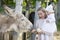 Mom with a little daughter feeds a donkey