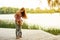 Mom and little daughter are fooling around on the pier near the lake. Learn to walk