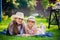 Mom and little daughter lying on the grass during a picnic - Love in the air, a woman with a girl on her back in a
