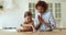 Mom and little daughter play draughts at home