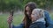 Mom and little daughter take selfies, make faces in the camera. Rest in the park