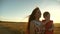 Mom and little daughter are walking along a country road in a wheat field. mother and baby walks in nature. Happy mom