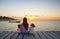 Mom and little daughters silhouette in the sunset