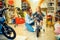 Mom and little girl buying bicycle in kid`s store