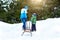 Mom and little son, go with sleds to the hill to ride. Winter fun for family Christmas vacation.