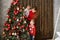 Mom with little sons decorates Christmas tree with red balls