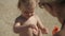 Mom lubricates her two-year-old daughter with sunscreen