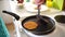 Mom makes pancakes. Women\'s hands remove the punks with a spatula from the pan.