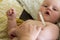 Mom measures the temperature of her baby with a mercury thermometer