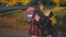 Mom meets her little daughter from school. Girl in school uniform with a backpack runs to her mother. Slow shooting