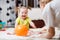 Mom playing ball with baby indoor