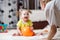 Mom playing ball with baby indoor