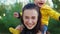 Mom plays with her child in the park at sunset. The boy sits on his shoulders in a yellow jacket and smiles happily