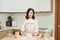 Mom prepares breakfast. A woman pours flour into a plate. The cooking process. Home kitchen