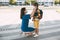 Mom puts a child a mask and escorts to school or kindergarten. A boy with a masked backpack during a coronavirus. Side view