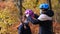 Mom puts on a medical mask and Bicycle helmet for her daughter in the fall . The concept of protection FROM covid-19 coronavirus