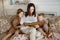 Mom reads a book to the children. A woman tells a story to a boy and a girl before going to bed. Mom daughter and son relax at