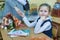 Mom says goodbye to her daughter elementary school student and holds her hand