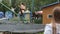 Mom shoots video use a smartphone as children jumping on the trampoline