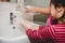 Mom shows daughter proper way to wash hands