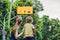 Mom shows his son a plate of shared lane and beware bike warning sign