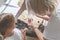 Mom shows little daughter how to make dumplings