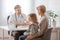 Mom and sick son in front of the handsome pediatrician`s desk