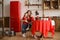 Mom, sitting at dining table, hugs two sons, in kitchen made of wood