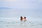 Mom and son Asians bathe in the sea - mother kisses the child