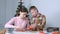 Mom and son baking making cooking gingerbread cookies together at home.