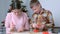 Mom and son baking making cooking gingerbread cookies together at home.