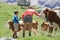 Mom and son caressing a cow during summer mountain holidays