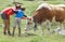 Mom and son caressing a cow during summer mountain holidays