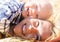 Mom and son lie on a haystack, look at the camera and smile