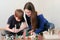 Mom and son looking at chemical reaction with gas emission. Experience with plasticine volcano at home.