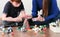 Mom and son make experience with plasticine volcano at home. Chemical reaction with gas emission.