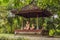Mom and son meditate practicing yoga in the traditional balinesse gazebo
