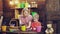 Mom and son plant and care for flowers. Woman and boy plant flowers in colorful pots on a wooden background.