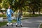 Mom and son ride a hoverboard in the park, a self-balancing scooter. Active lifestyle time with baby technology future