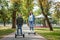 Mom and son ride a hoverboard in the park, a self-balancing scooter. Active lifestyle time with baby technology future