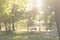 Mom and son are sitting on a bench in a park with a bicycle on a sunny day