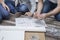 Mom and son spend their own furniture. They sit on the carpet and compare the piece of furniture with the illustration in the asse