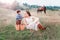 Mom and son together on a picnic in the field. Horse in the background