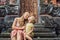 Mom and son travelers in the background of Pura Taman Kemuda Saraswati Temple in Ubud, Bali island, Indonesia BANNER