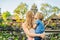 Mom and son travelers in the background of Pura Taman Kemuda Saraswati Temple in Ubud, Bali island, Indonesia Traveling