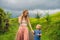 Mom and son travelers on Beautiful Jatiluwih Rice Terraces against the background of famous volcanoes in Bali, Indonesia