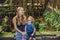 Mom and son travelers discovering Ubud forest in Monkey forest,