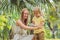 Mom and son use mosquito spray.Spraying insect repellent on skin