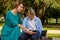 Mom and son using tablet and smartphone while sitting on nature. The family plays computer or searches the Internet